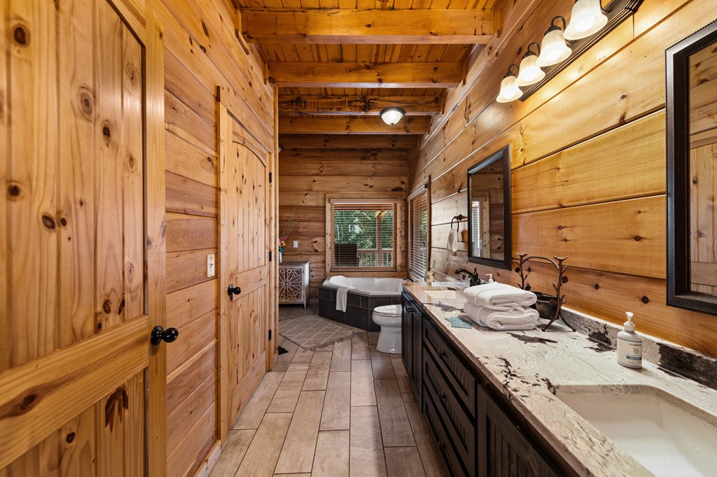 31 Hope Drive Blue Ridge, GA 30513 - Photo 28 of 80 a bathroom with a double vanity sink a large mirror and a bathtub