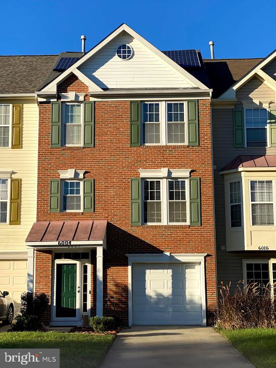 a front view of a residential apartment building with a yard