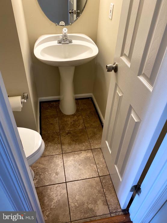 6004 Cedar Post Drive District Heights, MD 20747 - Photo 14 of 28 a bathroom with a sink a toilet a mirror and vanity