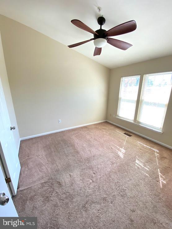 6004 Cedar Post Drive District Heights, MD 20747 - Photo 15 of 28 an empty room with ceiling fan and windows