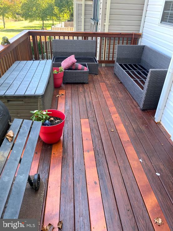 6004 Cedar Post Drive District Heights, MD 20747 - Photo 25 of 28 a balcony with wooden floor table and chairs