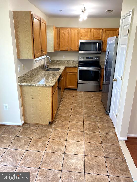 6004 Cedar Post Drive District Heights, MD 20747 - Photo 4 of 28 a kitchen with granite countertop a refrigerator a sink a stove a microwave and cabinets