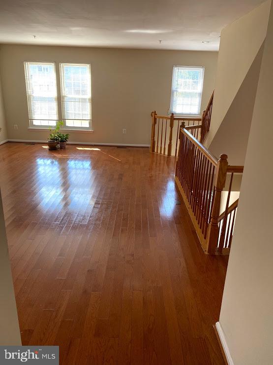 6004 Cedar Post Drive District Heights, MD 20747 - Photo 9 of 28 a view of an empty room with wooden floor and a window