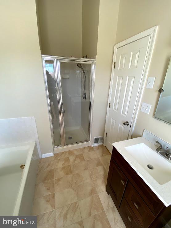 6004 Cedar Post Drive District Heights, MD 20747 - Photo 10 of 28 a bathroom with a sink a mirror and a shower