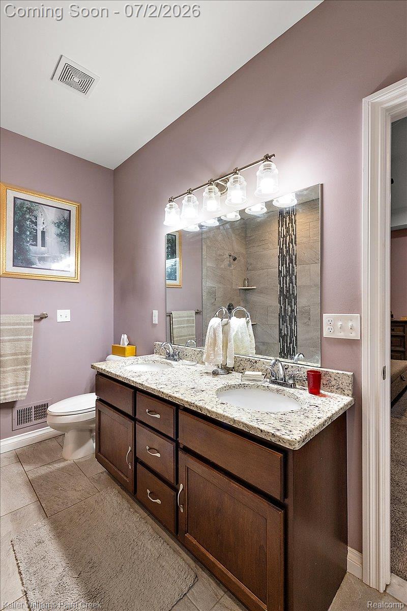 54230 Card Road Macomb, MI 48042 - Photo 52 of 73 Dual vanity with granite countertop, integrated sinks, and dark wood cabinetry