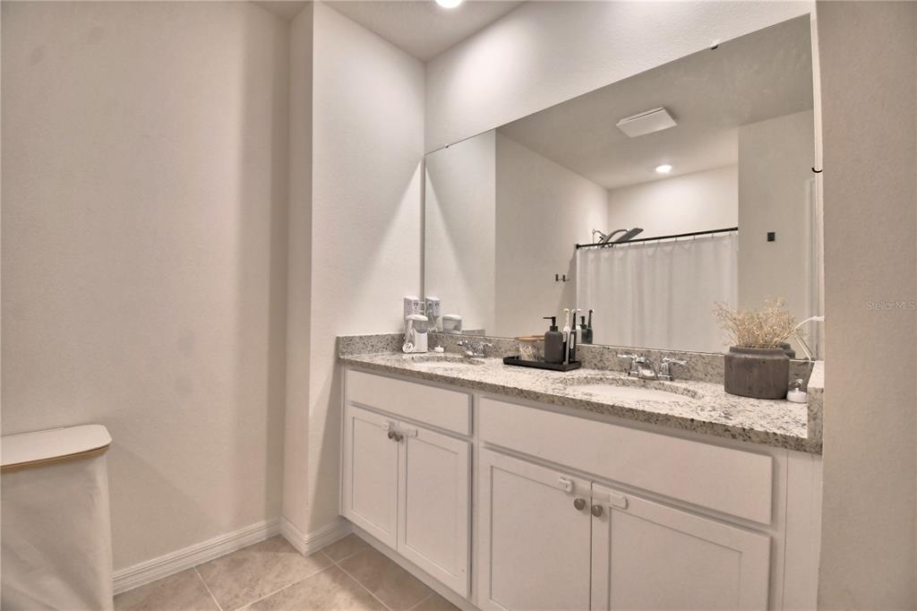 2839 Moulin Road Davenport, FL 33837 - Photo 39 of 75 a bathroom with a sink and a mirror