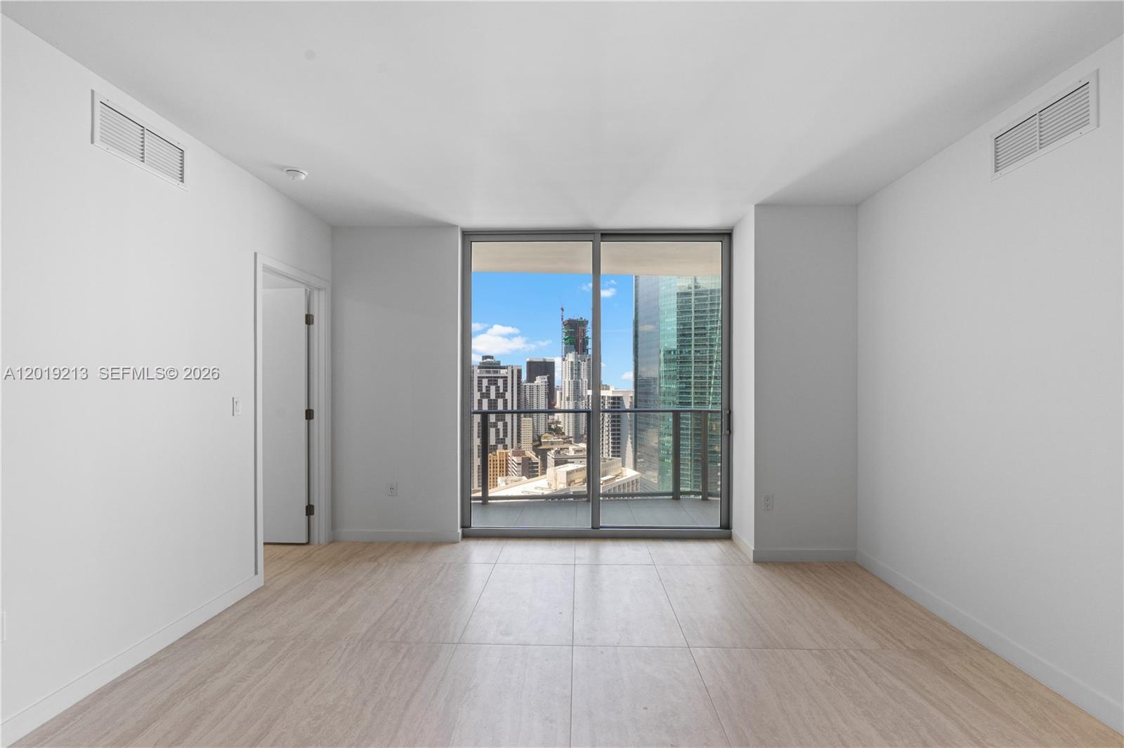 77 Southeast 5th, Unit 3702 Miami, FL 33131 - Photo 23 of 63 an empty room with wooden floor and door