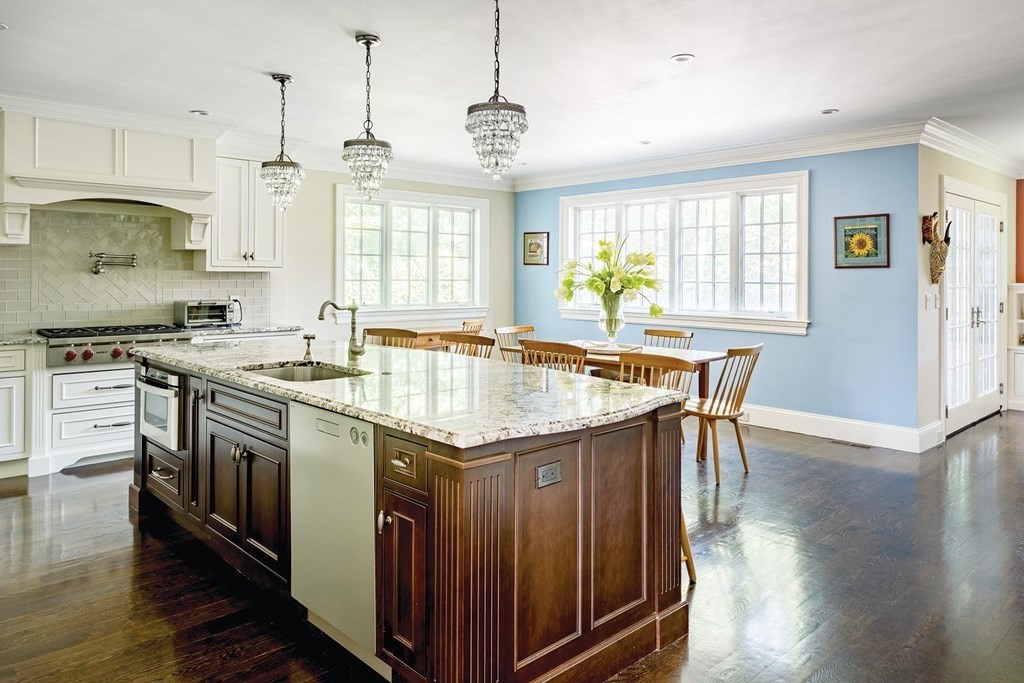 132 Hammond Street Newton, MA 02467 - Photo 5 of 17 a kitchen with stainless steel appliances granite countertop a stove a sink dishwasher a refrigerator white cabinets with wooden floor