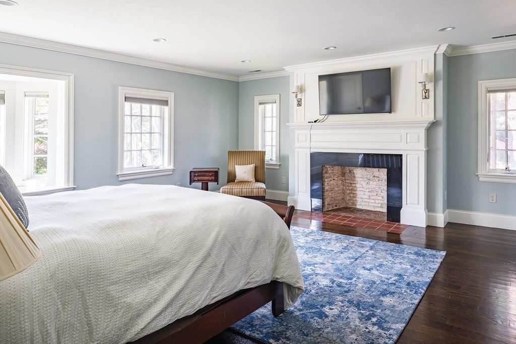 132 Hammond Street Newton, MA 02467 - Photo 9 of 17 a spacious bedroom with a bed and a fireplace