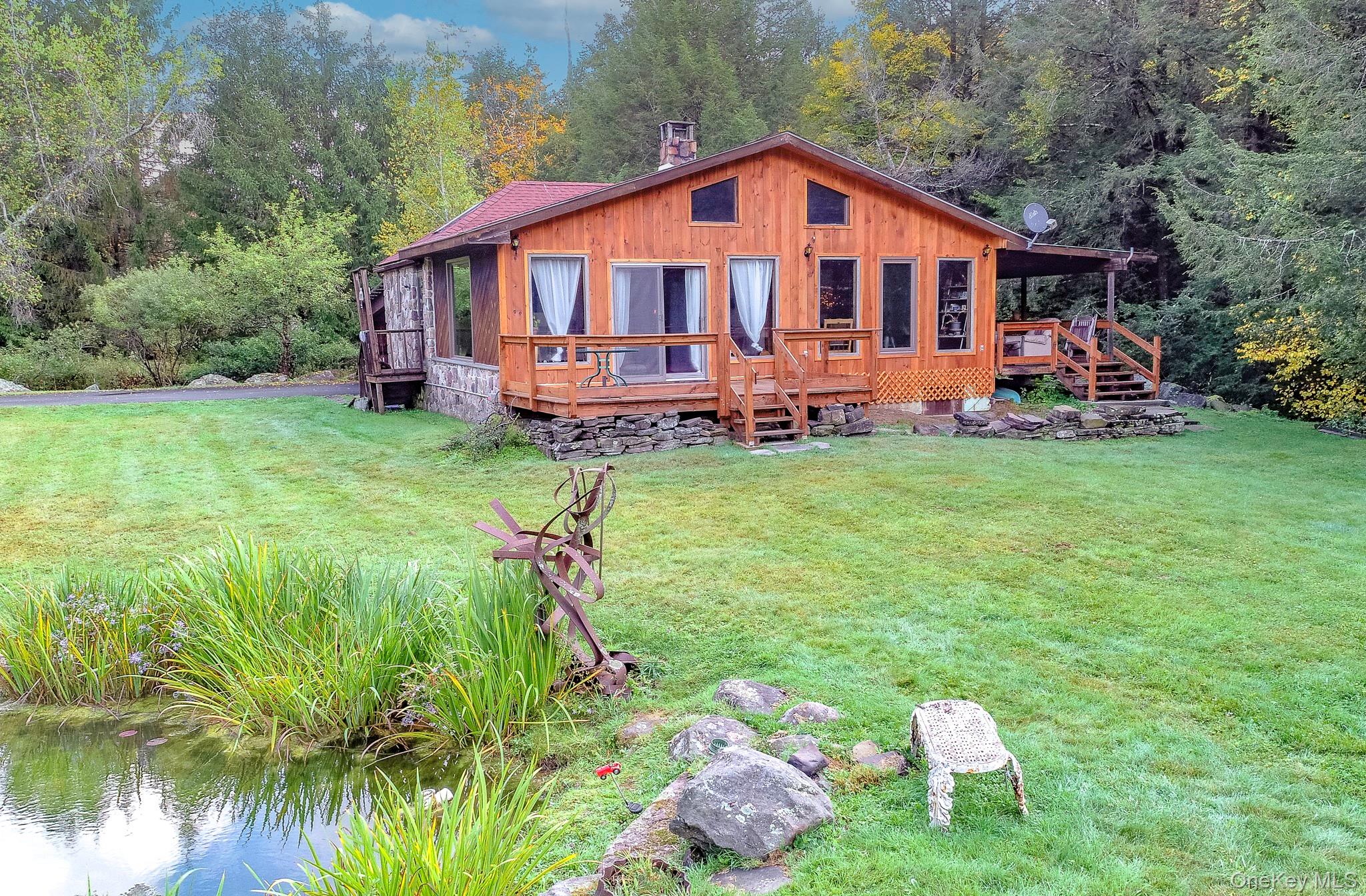 178 Aden Road Liberty, NY 12754 - Photo 2 of 27 a front view of a house with garden