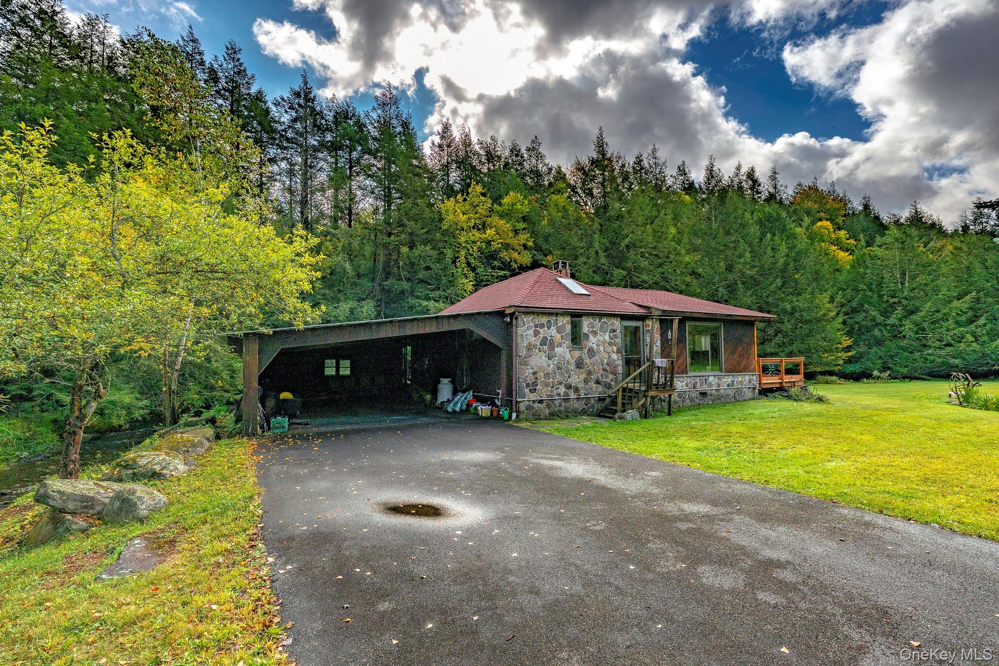 178 Aden Road Liberty, NY 12754 - Photo 26 of 27 a view of a patio with table and chairs under an umbrella