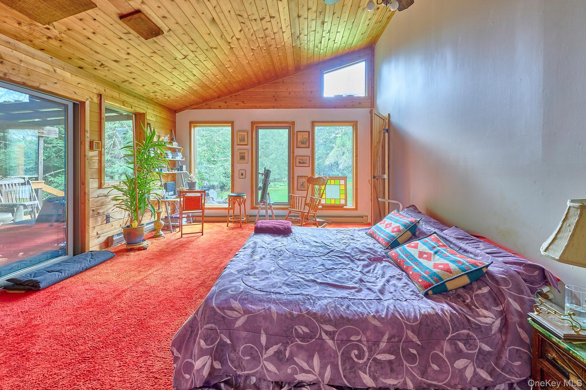 178 Aden Road Liberty, NY 12754 - Photo 9 of 27 a bedroom with a bed and large windows