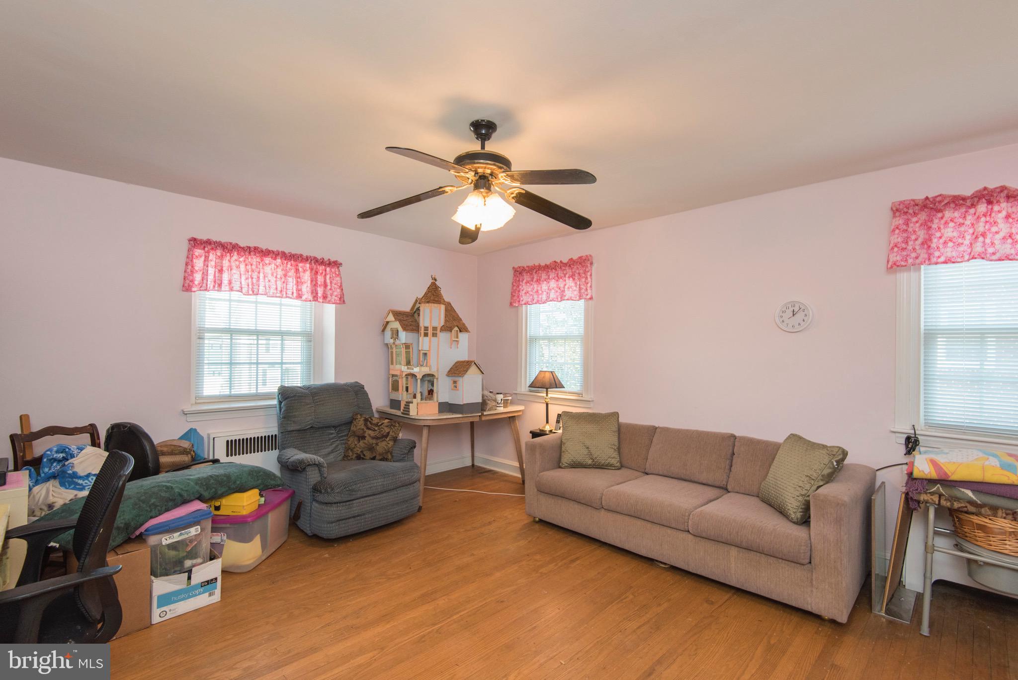 9 Fairfield Road Havertown, PA 19083 - Photo 21 of 31 a living room with furniture a fireplace and a window