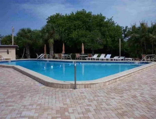 a view of a swimming pool with chairs