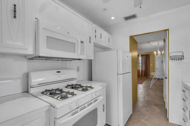 a kitchen that has a stove and a refrigerator