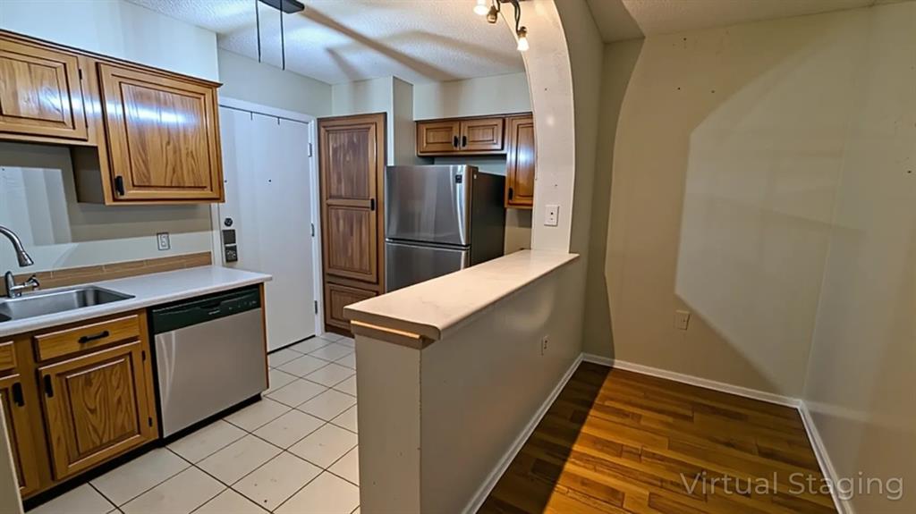 13217 Emily Road, Unit 3103 Dallas, TX 75240 - Photo 12 of 24 a kitchen with stainless steel appliances granite countertop a refrigerator and a stove