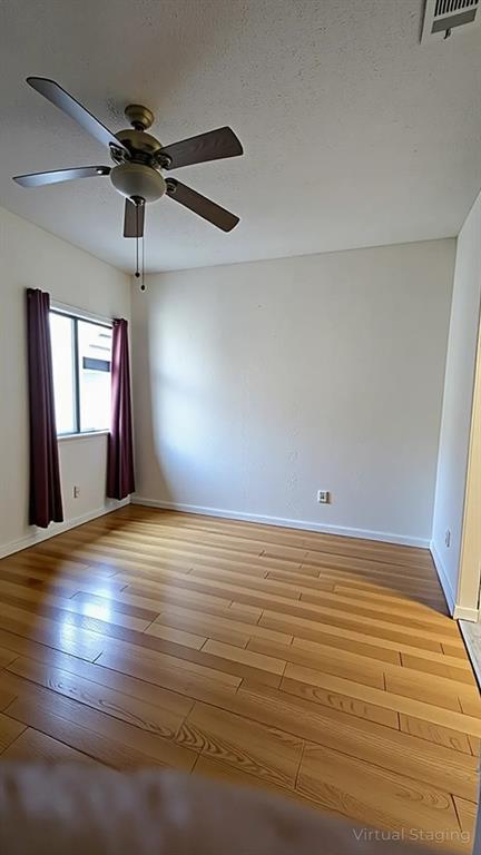 13217 Emily Road, Unit 3103 Dallas, TX 75240 - Photo 14 of 24 a view of empty room with wooden floor and fan