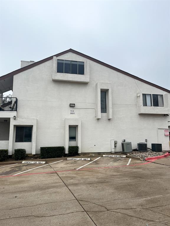 13217 Emily Road, Unit 3103 Dallas, TX 75240 - Photo 21 of 24 a front view of a house with a yard