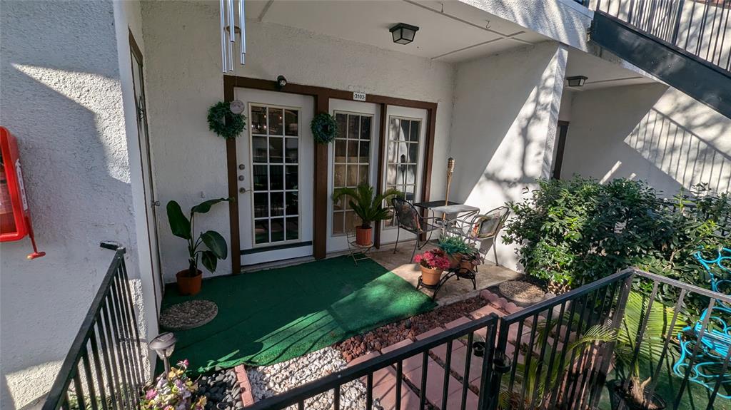 13217 Emily Road, Unit 3103 Dallas, TX 75240 - Photo 3 of 15 a view of a house with backyard and sitting area