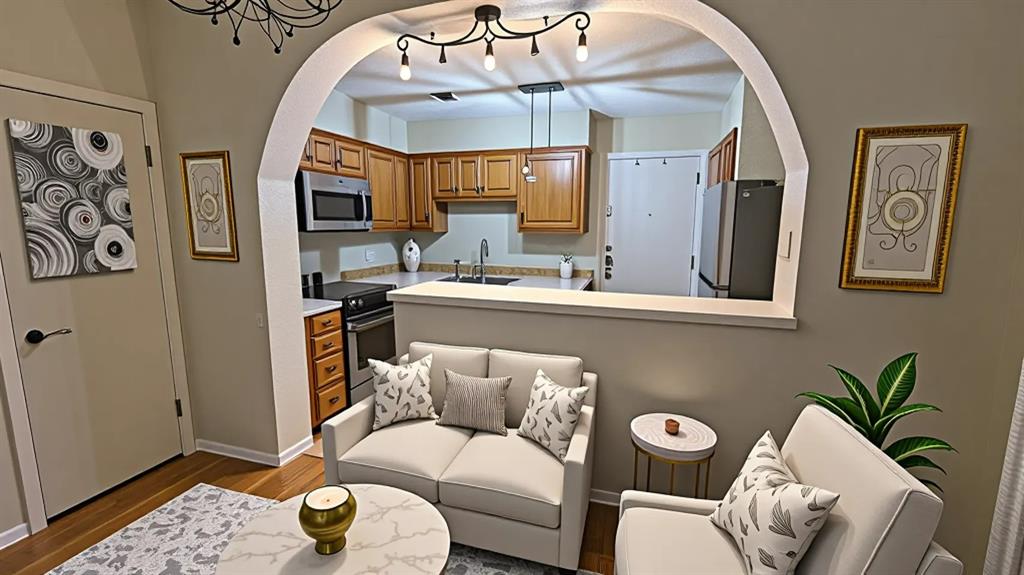 13217 Emily Road, Unit 3103 Dallas, TX 75240 - Photo 4 of 24 a living room with furniture flowerpot and a chandelier