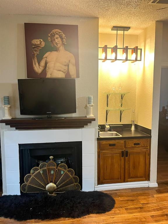 13217 Emily Road, Unit 3103 Dallas, TX 75240 - Photo 8 of 24 a living room with a fireplace and a table