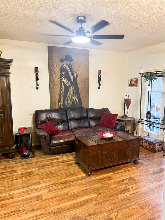 13217 Emily Road, Unit 3103 Dallas, TX 75240 - Photo 9 of 24 a living room with furniture and a wooden floor