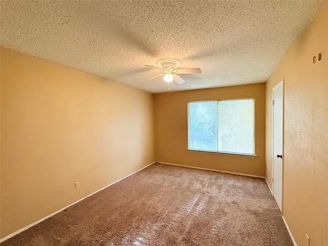 a view of a hallway with a ceiling fan