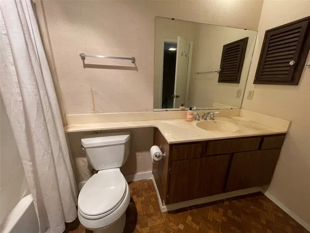 a bathroom with a sink a toilet and mirror