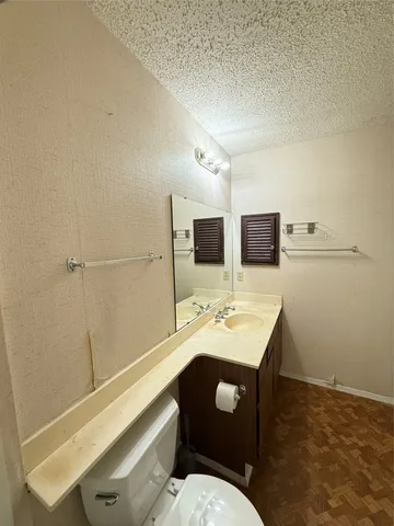a bathroom with a sink a toilet and mirror
