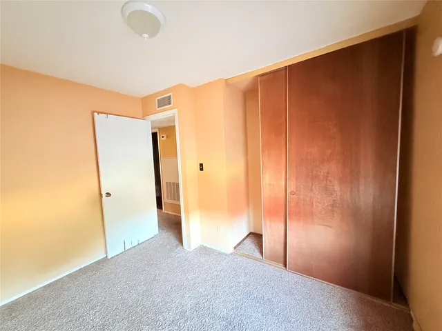 a view of a backyard with plants and furniture