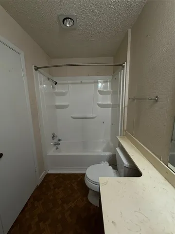a bathroom with a bathtub and a toilet