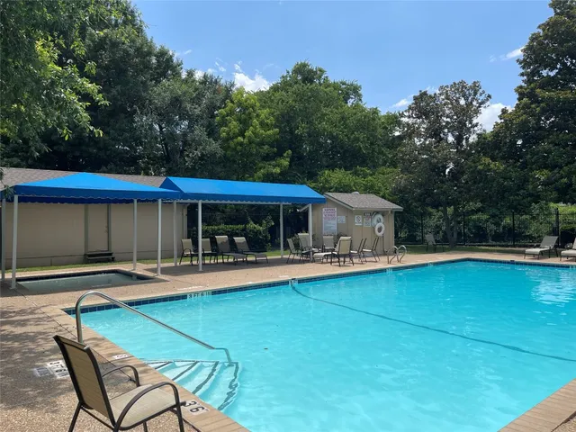 a patio with wooden table and chairs