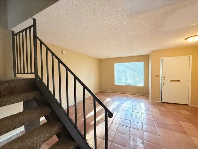 a view of entryway with stairs and wooden floor