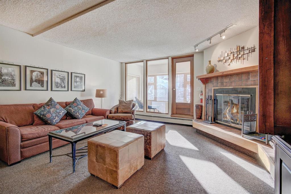 a living room with furniture large window and fireplace