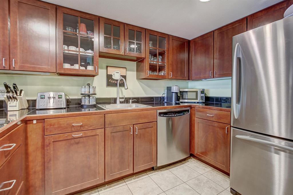800 Copper Road, Unit 104 Copper Mountain, CO 80443 - Photo 8 of 32 a kitchen with stainless steel appliances granite countertop a refrigerator and a sink