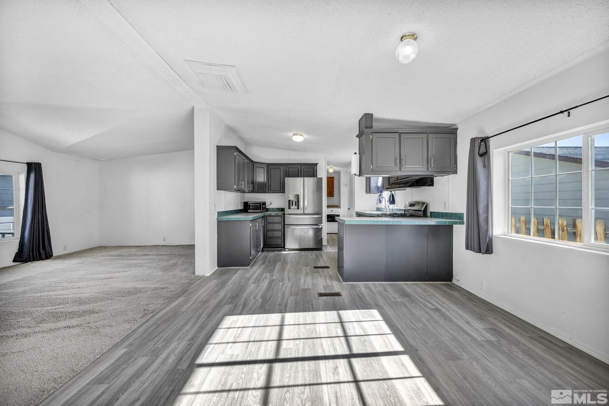 16245 Autunite Circle Reno, NV 89521 - Photo 23 of 37 a kitchen with stainless steel appliances granite countertop a stove a sink and a refrigerator