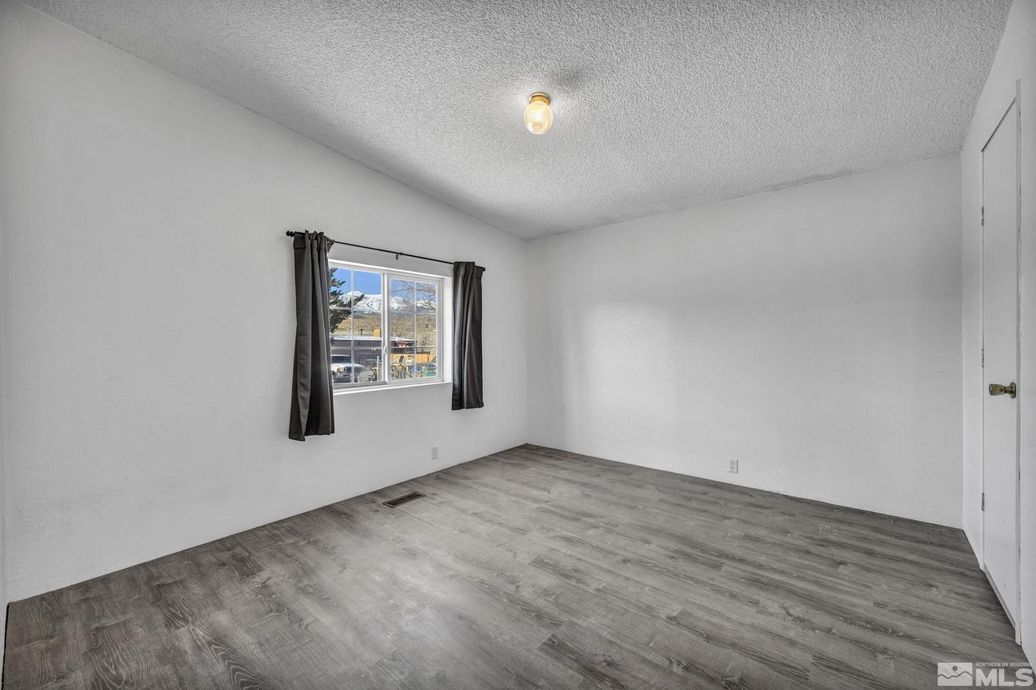 16245 Autunite Circle Reno, NV 89521 - Photo 34 of 37 an empty room with wooden floor and windows