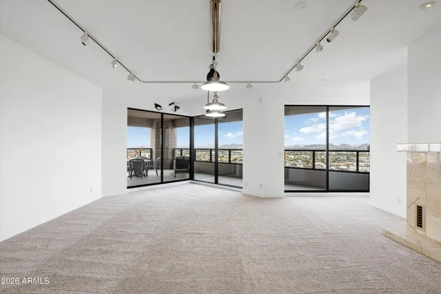 a large white kitchen with lots of counter space and glass door