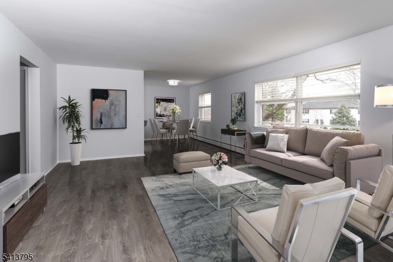 500 Main Street, Unit 3D Chatham, NJ 07928 - Photo 2 of 15 a living room with furniture and a large window