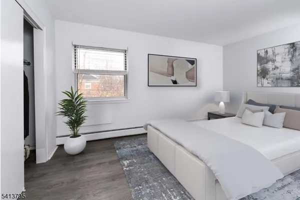 a bedroom with a potted plant and a window