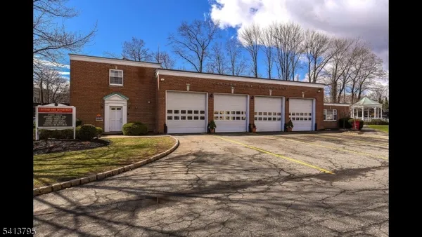 a front view of a building with a yard and garage