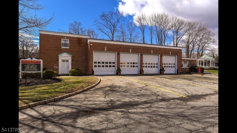 500 Main Street, Unit 3D Chatham, NJ 07928 - Photo 4 of 15 a front view of a building with a yard and garage