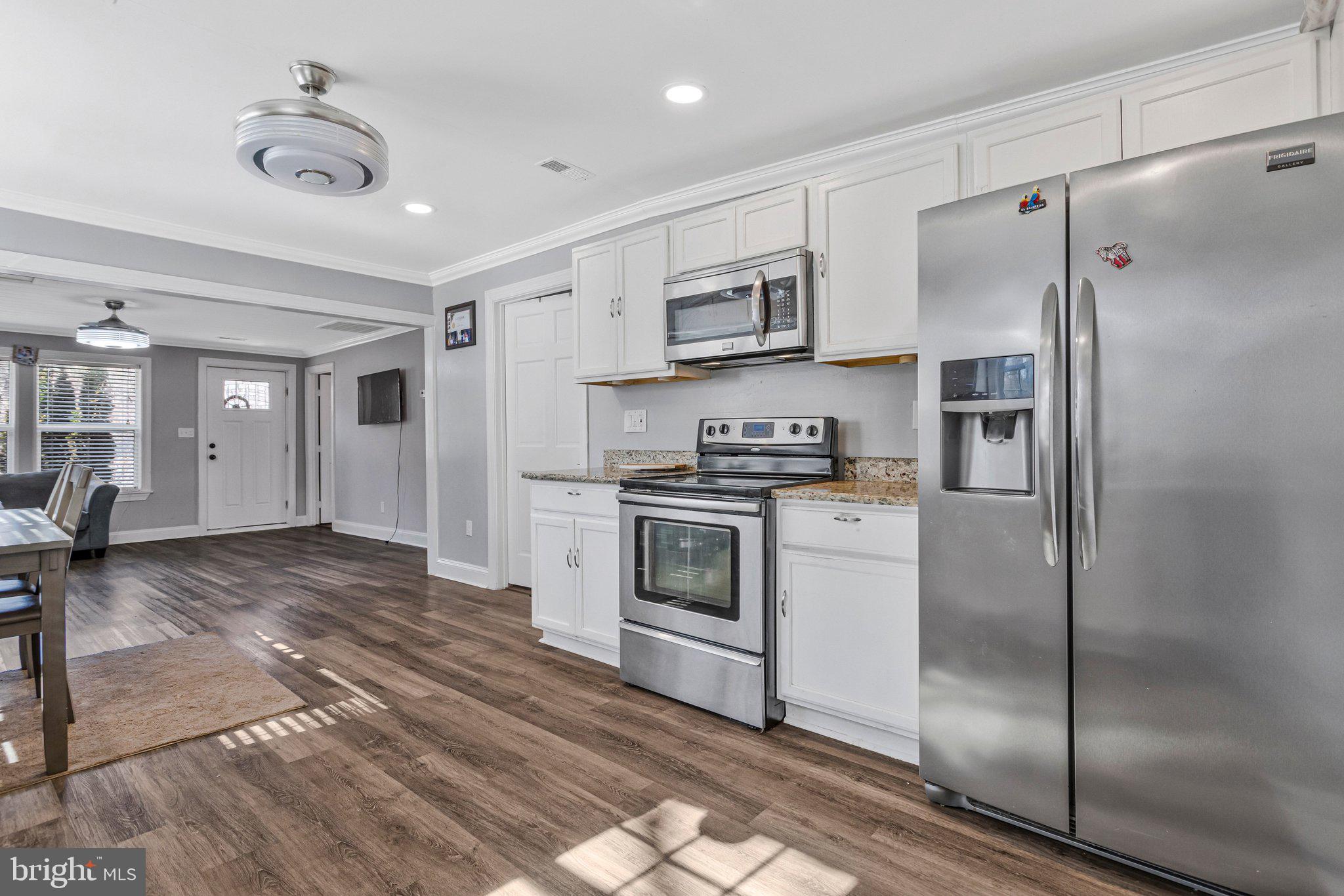 4103 Port Tobacco Road Nanjemoy, MD 20662 - Photo 4 of 19 a kitchen with stainless steel appliances granite countertop a refrigerator a stove and a sink
