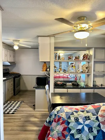 a kitchen with stainless steel appliances kitchen island granite countertop a sink and a stove