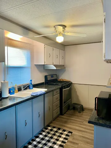 a kitchen with a sink stove and cabinets