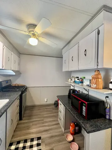 a kitchen with stainless steel appliances granite countertop a stove a sink and cabinets