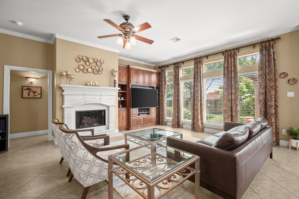 a living room with furniture large window and a fireplace