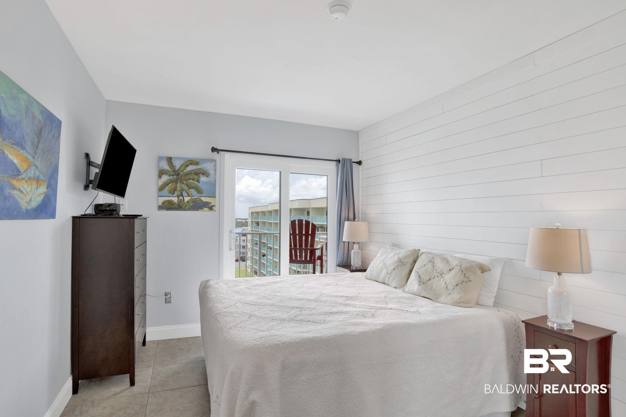 375 Plantation Road, Unit 5514 Gulf Shores, AL 36542 - Photo 22 of 44 Bedroom featuring access to exterior, wooden walls, and light tile patterned flooring