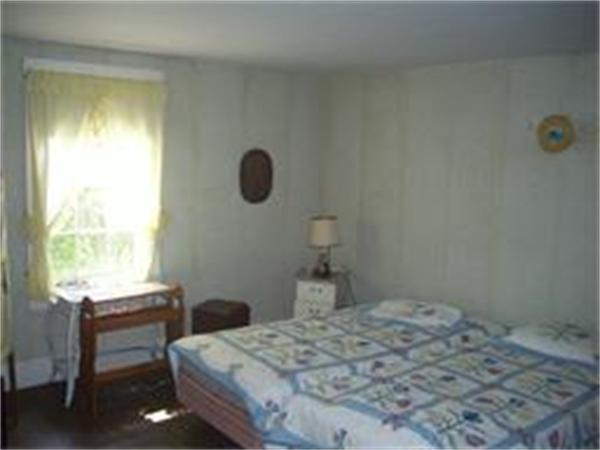 36 Smith Road Chester, MA 01050 - Photo 10 of 16 a bedroom with a bed and a window