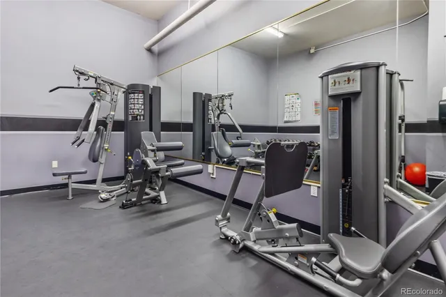 a room with gym equipment and windows